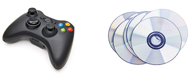 New Uses black game controller and stack of CDs and DVDs against white background