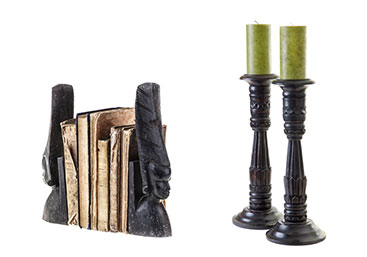 New Uses home accessories: two black bookends with face profiles and two black candlesticks with small green candles against white background